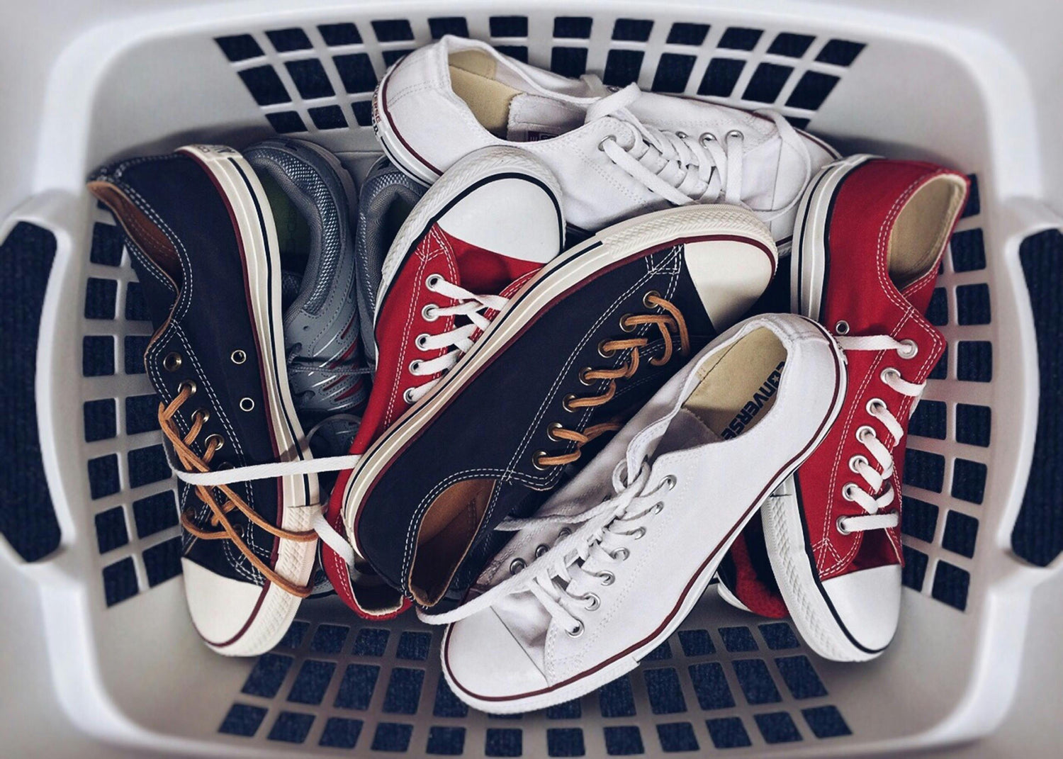 clean shoes that are sitting in a laundry basket